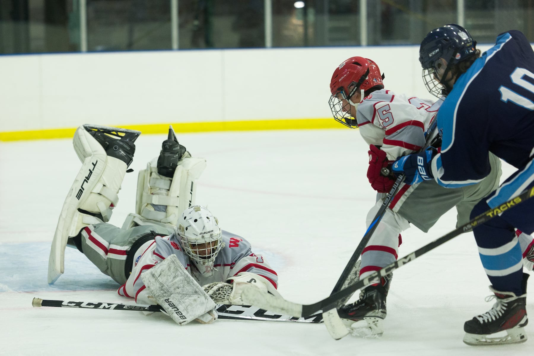 Hoboken goalie Christian Ferullo (left) dives to the cover the puck against A.L. Johnson in Sunday's high school boys ice hockey showdown in Roselle. Johnson out-skated the Redwings 4-1.  01/11/2026