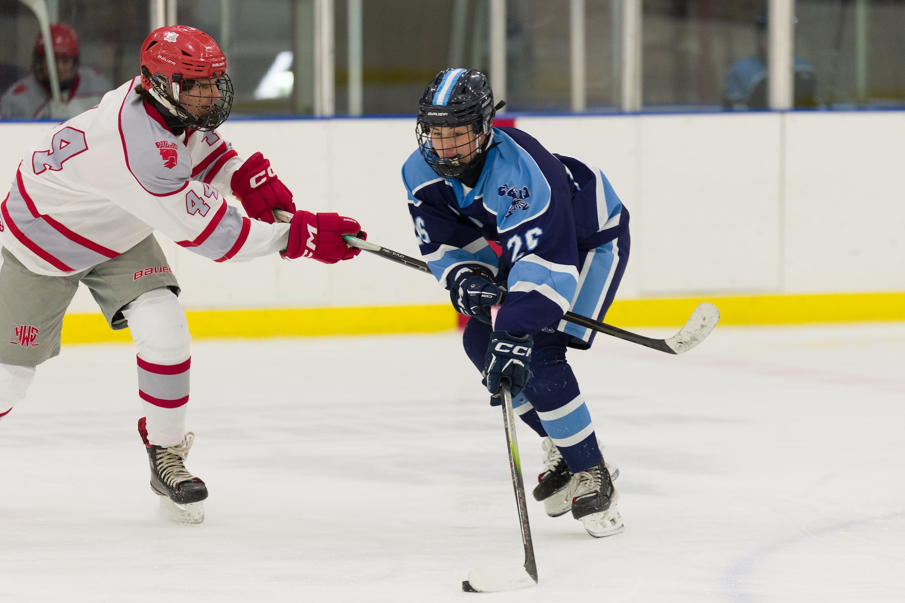 Logan Paskewich of A.L. Johnson (26) shoots the puck past Maxim Schissler of Hoboken (44) in Sunday's high school boys ice hockey showdown in Roselle. Johnson out-skated the Redwings 4-1.  01/11/2026