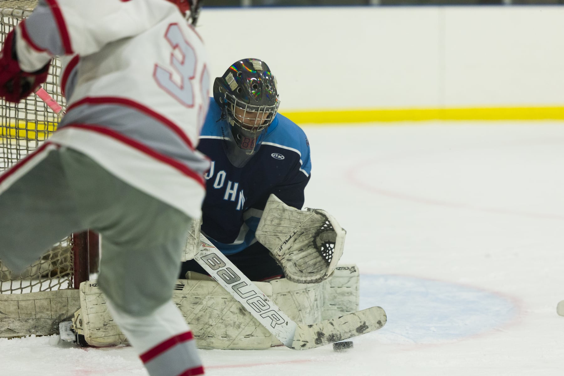 A.L. Johnson goalie Gia Amores makes the stop against Hoboken in Sunday's high school boys ice hockey showdown in Roselle. Johnson out-skated the Redwings 4-1.  01/11/2026