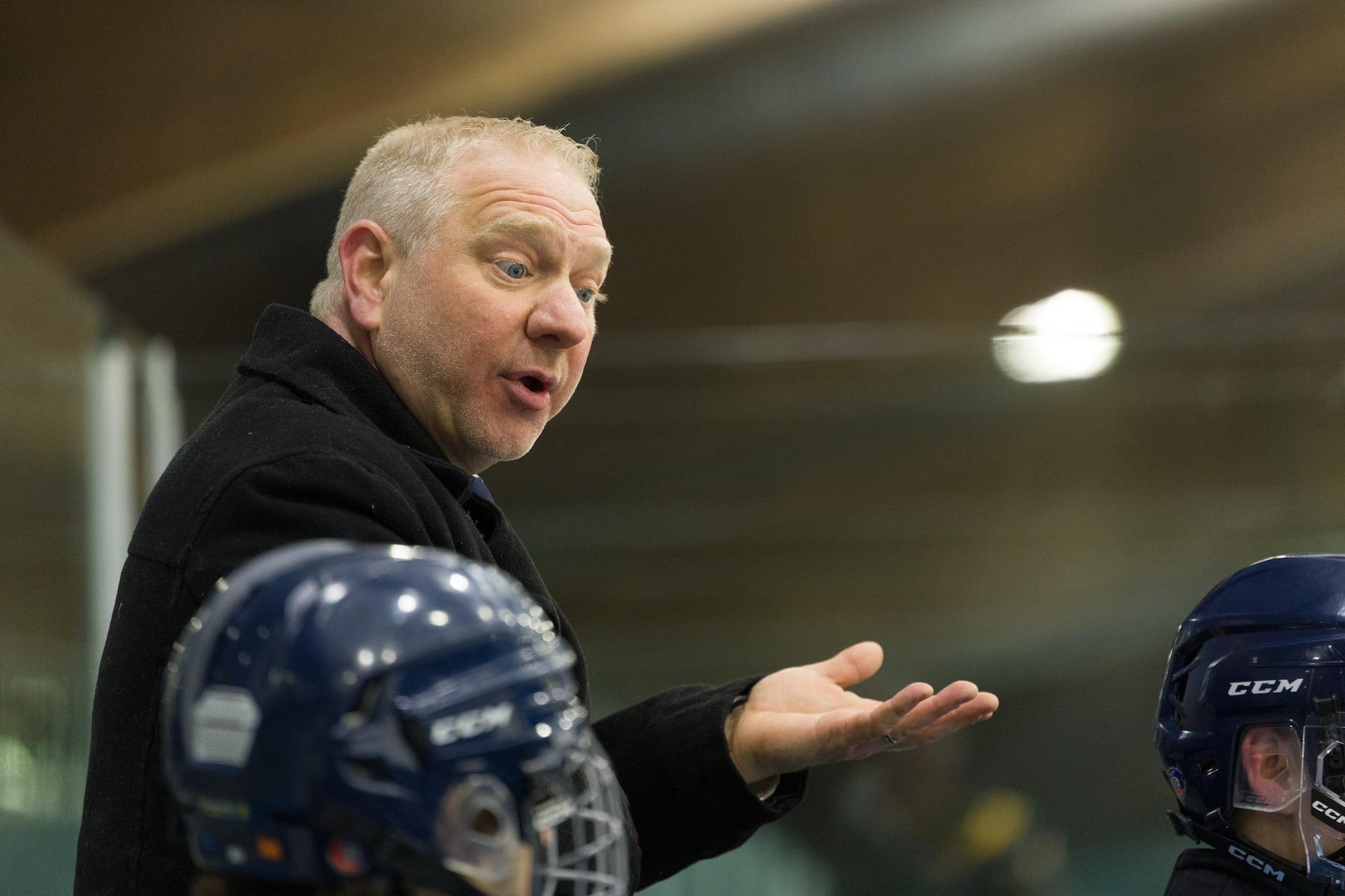 A.L. Johnson head coach Chris Enrico guides his skaters past Hoboken in Sunday's high school boys ice hockey showdown in Roselle. Johnson out-skated the Redwings 4-1.  01/11/2026
