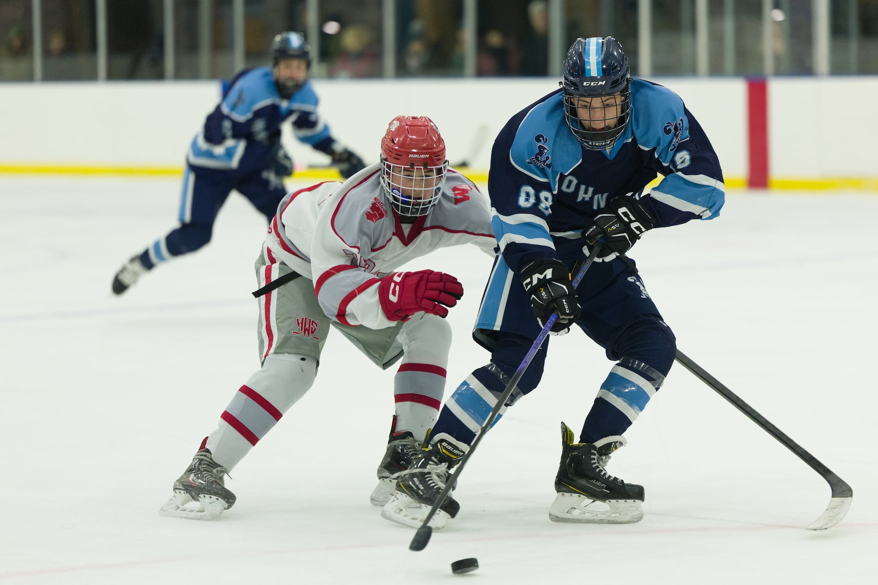 Sammy Zapotoka of A.L. Johnson (73) skates the puck past Hoboken's Patrick Smith (77) in Sunday's high school boys ice hockey showdown in Roselle. Johnson out-skated the Redwings 4-1.  01/11/2026