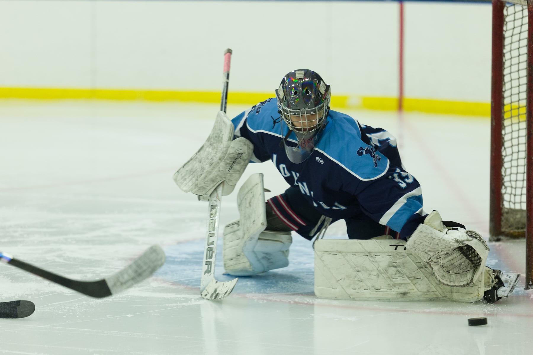 A.L. Johnson goalie Gia Amores knocks the puck away against Hoboken in Sunday's high school boys ice hockey showdown in Roselle. Johnson out-skated the Redwings 4-1.  01/11/2026