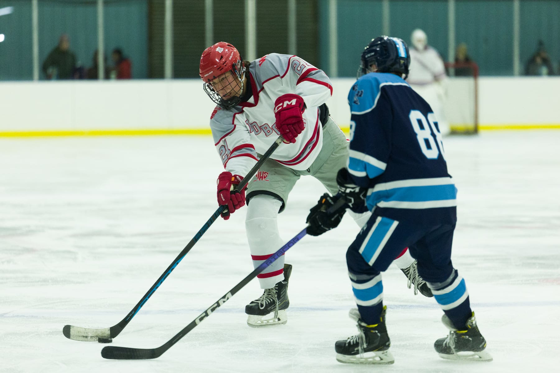 Billy Worman of Hoboken (21) fires past Sammy Zapotoka of A.L. Johnson (88) in Sunday's high school boys ice hockey showdown in Roselle. Johnson out-skated the Redwings 4-1.  01/11/2026