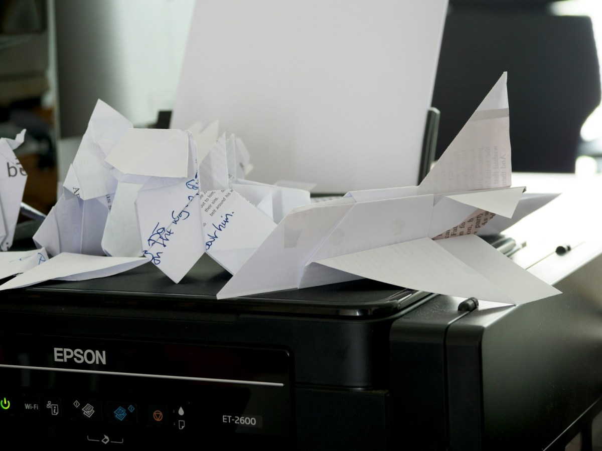 a bunch of papers sitting on top of a printer