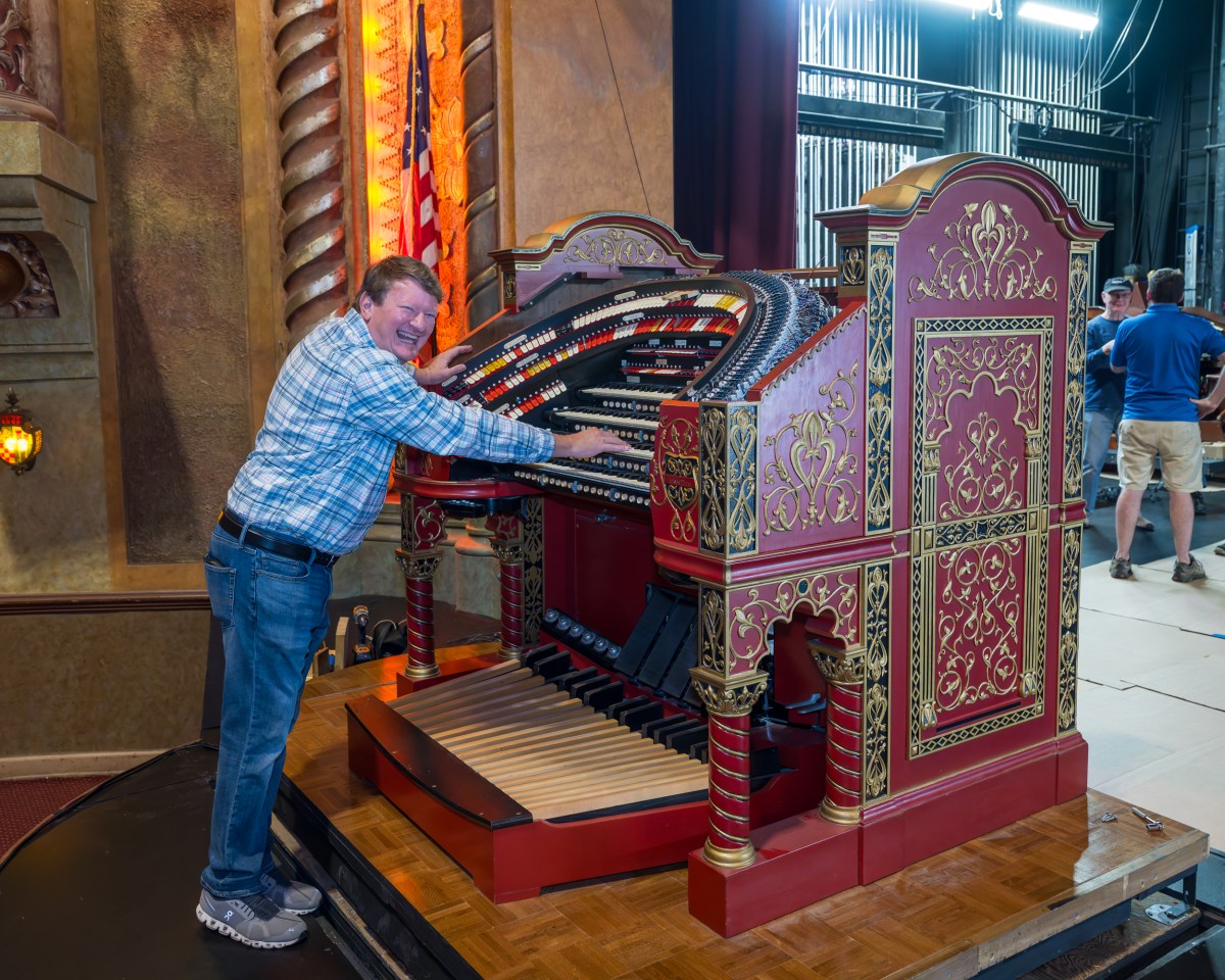 Alabama Theatre hosting first dual-console organ concert this weekend 2 a man standing next to a large organ