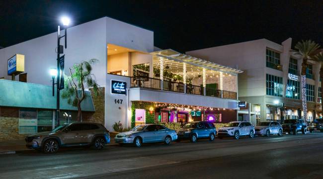 The Chinitas Tapas & Sushi exterior is vibrantly lit and inside serving customers along Wat ...