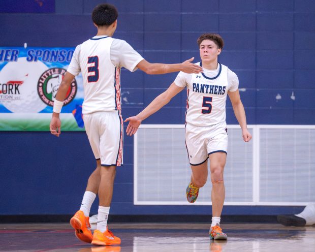 Oswego's Mariano Velasco (5) celebrates with Ethan Vahl (3) after a late game three point shot against Metea Valley during a non conference game in Oswego on Wednesday, Jan. 21, 2026. (Jeremy Toney / for the The Beacon-News)