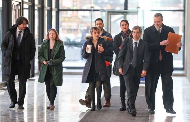 Congressional candidate Katherine "Kat" Abughazaleh, center, and her deputy campaign manager Andre Martin, far left, leave with their attorneys from the Dirksen U.S. Courthouse in the Loop on Jan. 28, 2026, after a hearing on charges of conspiracy during a protest outside the Broadview ICE facility in September. (Eileen T. Meslar/Chicago Tribune)