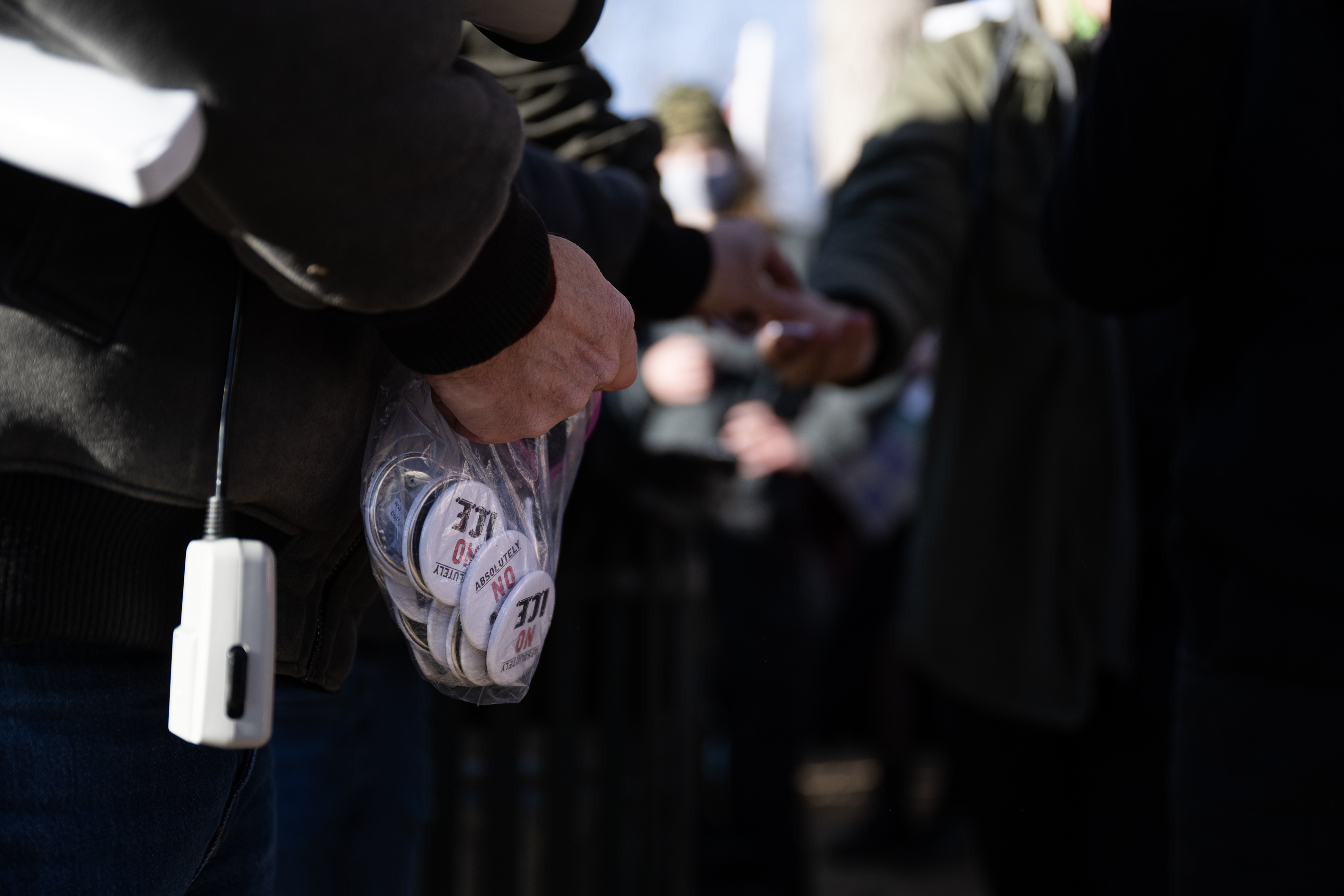 Michael Hommel hands out buttons during a gathering at La...