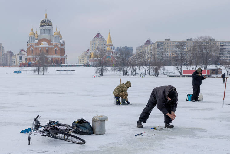REUTERS/THOMAS PETER
                                Men fish in a frozen lake, amid Russias attack on Ukraine, on a cold winter day in a left-bank neighborhood in Kyiv, in Ukraine.