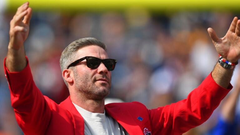 Former New England Patriots wide receiver Julian Edelman, right, greets the crowd during Patriots Hall of Fame ceremonies for Edelman during halftime at an NFL football game against the Pittsburgh Steelers, Sunday, Sept. 21, 2025, in Foxborough, Mass.