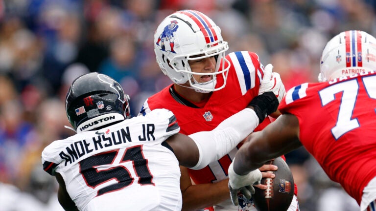New England Patriots quarterback Drake Maye (10) is sacked by Houston Texans defensive end Will Anderson Jr. (51) during the second quarter at Gillette Stadium.