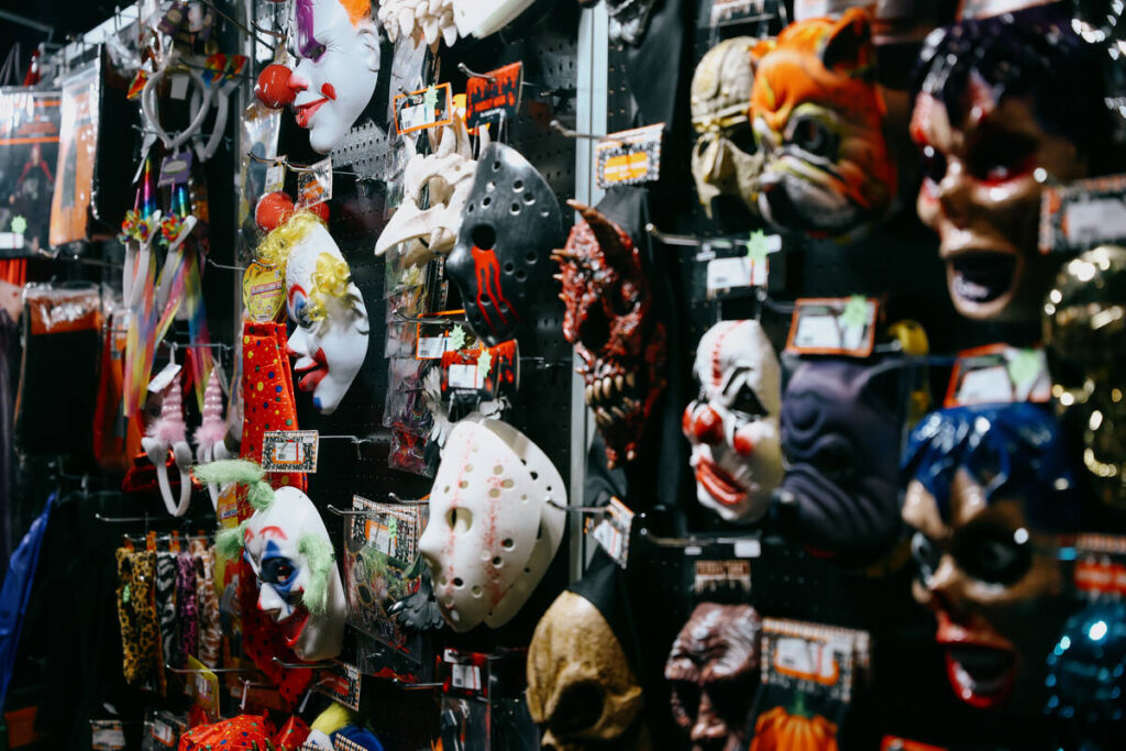 Masks hang on a display wall during the Halloween and Costume Association’s Second Annua ...