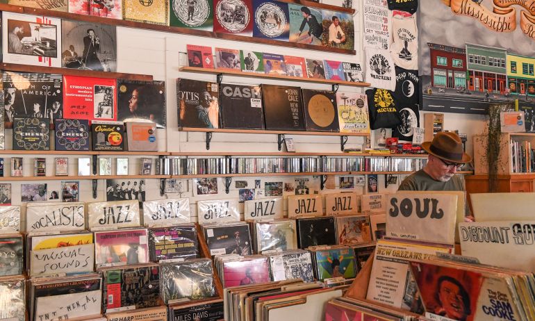 A man browses bins of records in a vintage record store