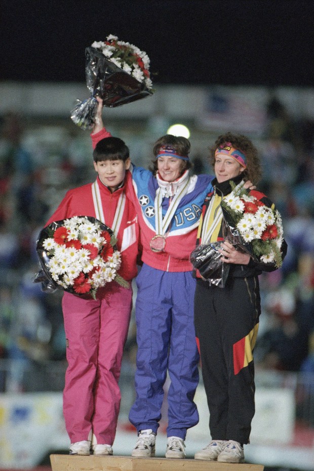 U.S. speed skater Bonnie Blair waves flowers after winning the gold medal in the women's 500-meter race at the XVI Winter Olympics in Albertville, France, on Feb. 10, 1992. Flanking Blair is silver medal winner Qiaobo Ye of China, left, and bronze medal winner Christa Luding of Germany. Some thought they represented the past, present and future of speed skating. (John Gaps III/AP)