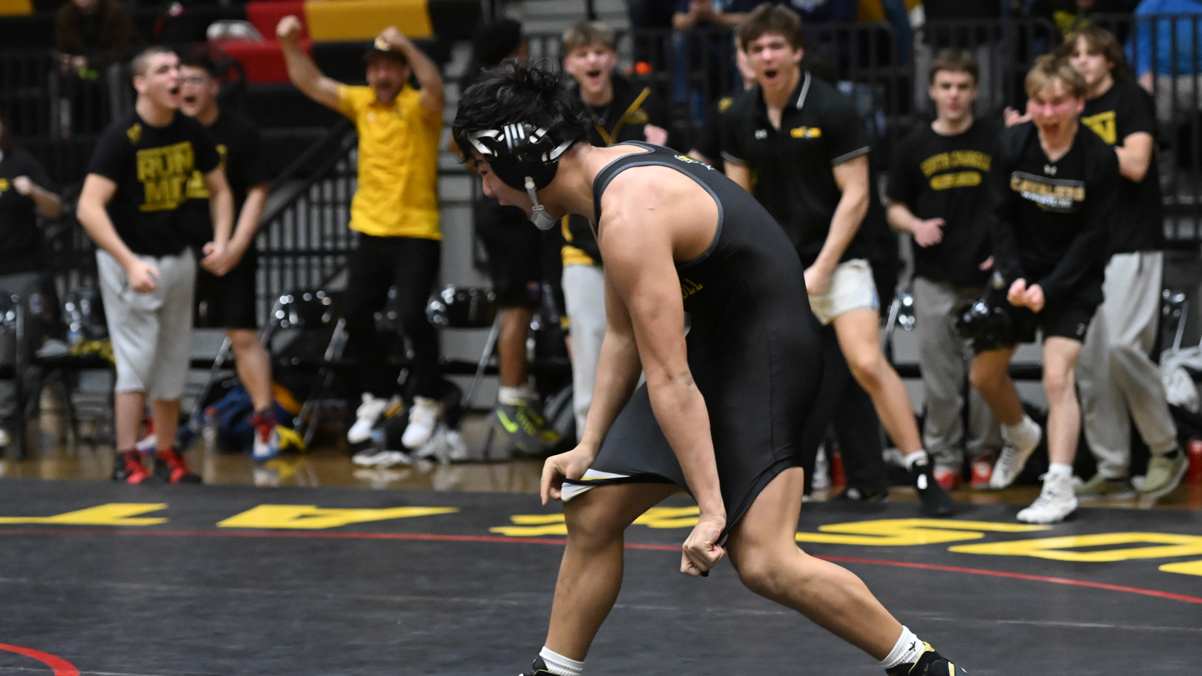 South Carroll's Quin Regnier celebrates his win by fall over...