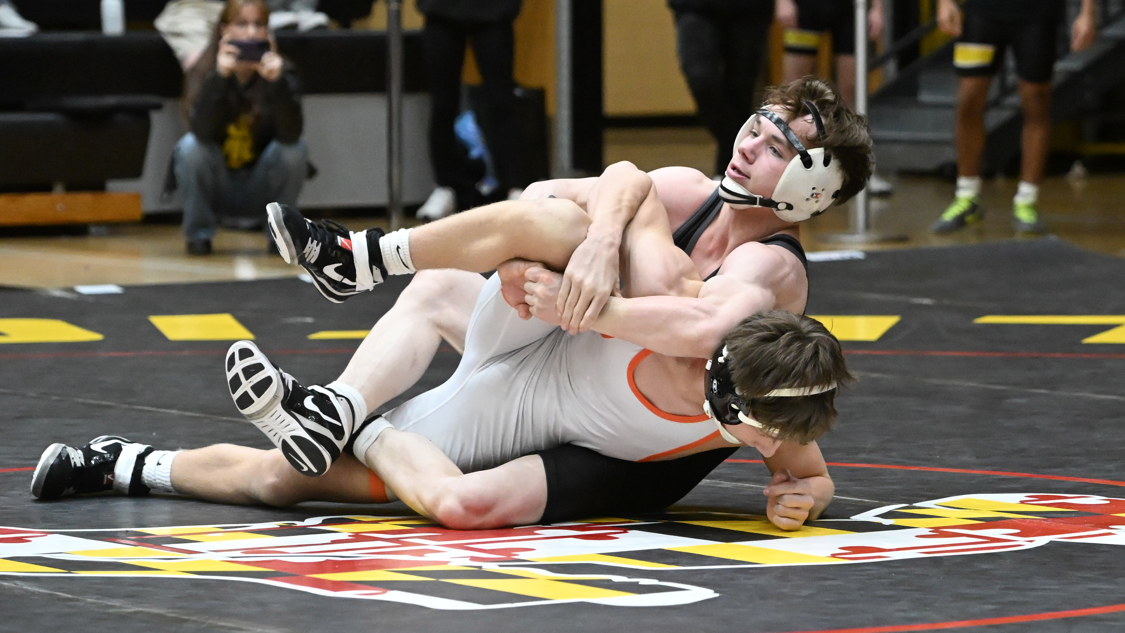 South Carroll's Grayson Barnhill, top, controls Rising Sun's Reyn Placentino...