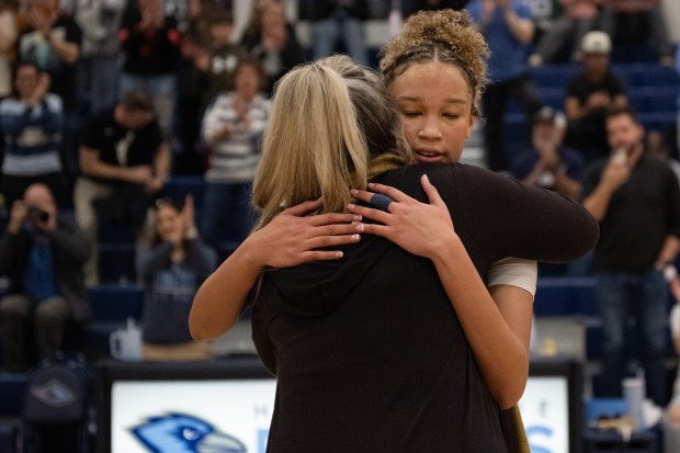Riverdale Ridge senior Brihanna Crittendon (3) meets with Ridgway alumni Tracy Hill after Crittendon scored to become the all-time leading scorer in Colorado high school basketball history during a game against Monarch on Saturday, Feb. 14, 2026, at Riverdale Ridge High School in Thornton, Colo. Hill held the previous record of 2,934 points for 43 years. (Photo by Timothy Hurst/The Denver Post)