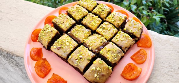 Persimmon Cake is topped with a halva glaze made with powdered sugar and lemon juice as well as chopped pistachios. (Photo by Yakir Levy)