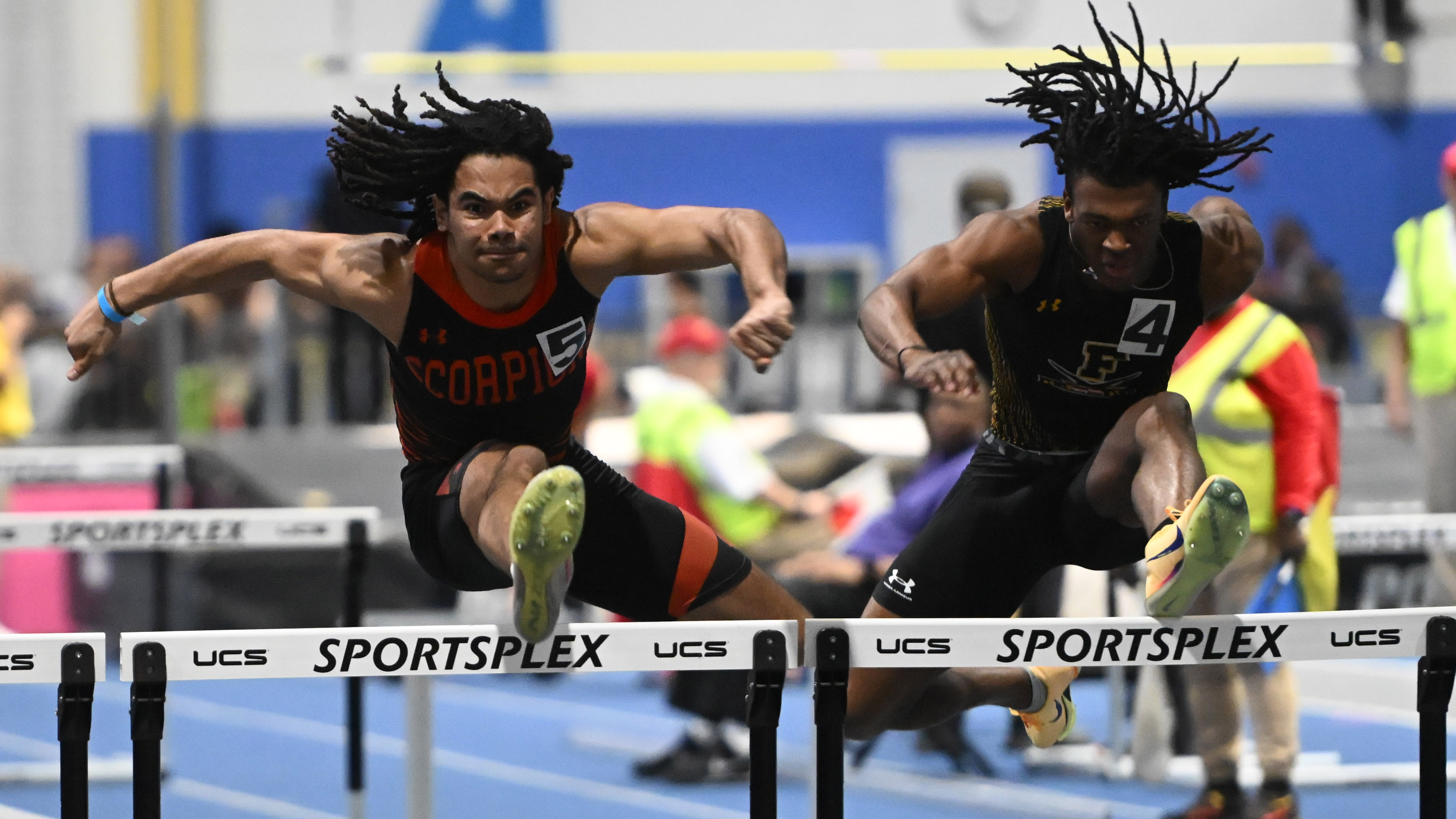 Oakland Mills' AJ York, left, and Frederick's Osahon Aigbogun compete in the 3A boys 55 meter hurdles during the track and field state championships at Prince Georges' Sports Complex on Wednesday. (Brian Krista/Staff)