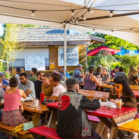 people sitting at tables eating food
