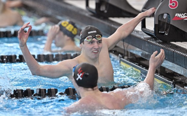 Marmian's Dan Ginaitis congratulates teammate, Brayden Capen after Capen won the 200 Yard IM, with a time of 1:45.77 during Saturday's IHSA boys swimming state meet, February 28, 2026. Ginaitis was 2nd in the event, with a time of 1:47.18. (Brian O'Mahoney for the Chicago Tribune)