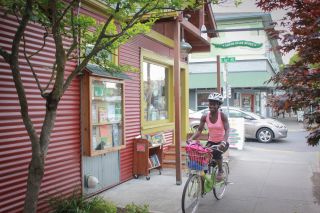 a cyclsit on their bike outside of Green Bean Books