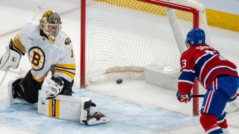 Montreal Canadiens' Cole Caufield (13) scores on Boston Bruins goaltender Jeremy Swayman (1) during overtime NHL hockey action in Montreal on Tuesday, March 17, 2026.