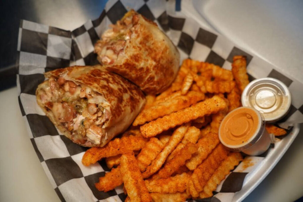 A smoked chicken and green chile burrito with seasoned crinkle-cut 303 fries from 303 in the Cu ...