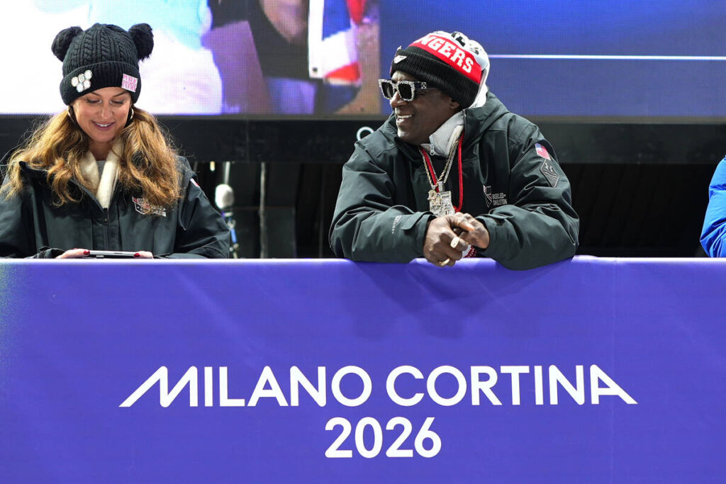 American rapper Flavor Flav, right, attends the skeleton mixed team competition at the 2026 Win ...