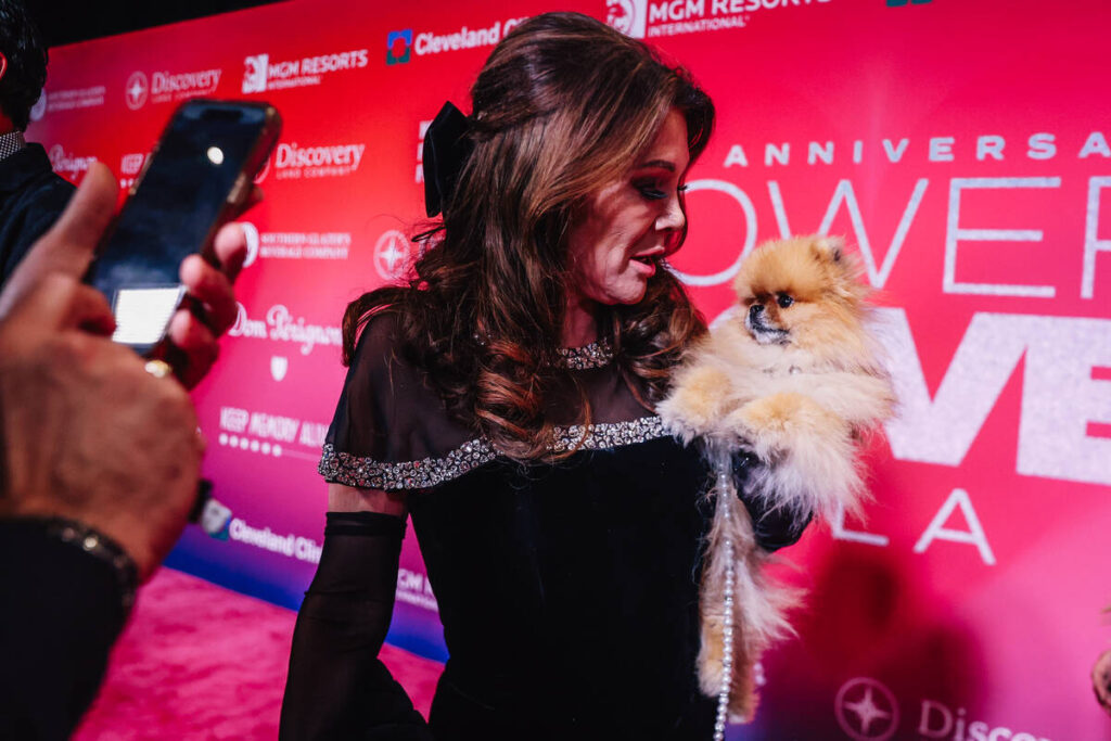 Lisa Vanderpump holds her dog, Donut, on the Power of Love Gala red carpet at MGM Grand Garden ...