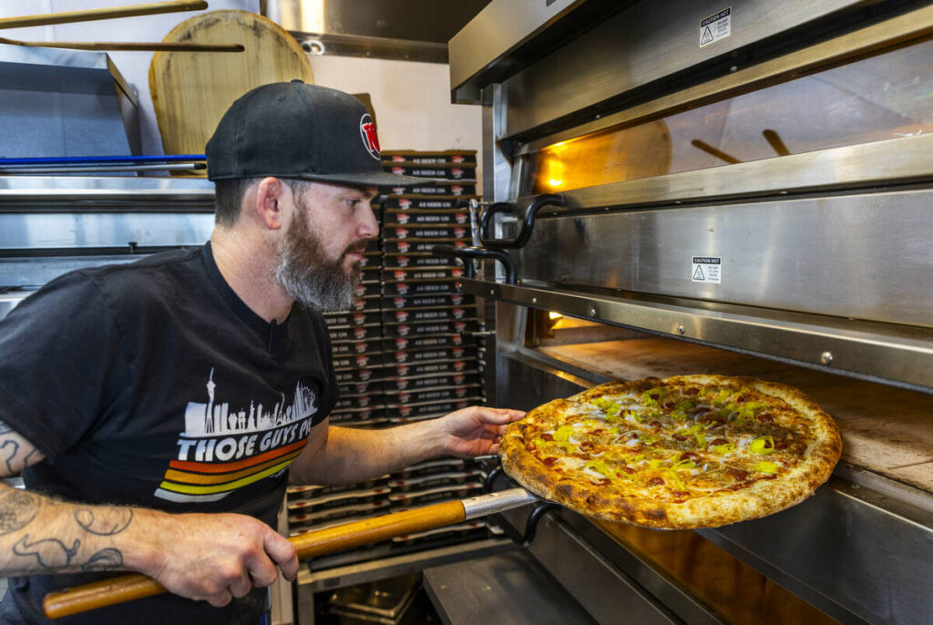 Chris Builder, co-founder and co-owner, checks on the baking as he prepares a Big Sexy pie at T ...