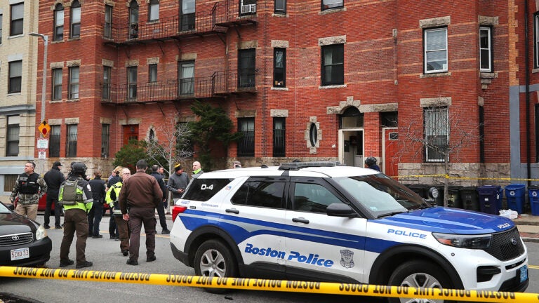 Boston police officers investigate a fatal shooting on Hemenway Street near the Northeastern University campus.