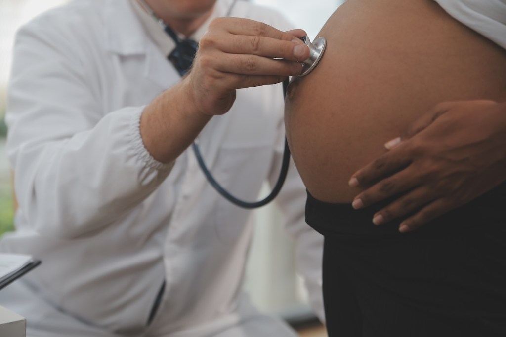 pregnant Black woman, white doctor
