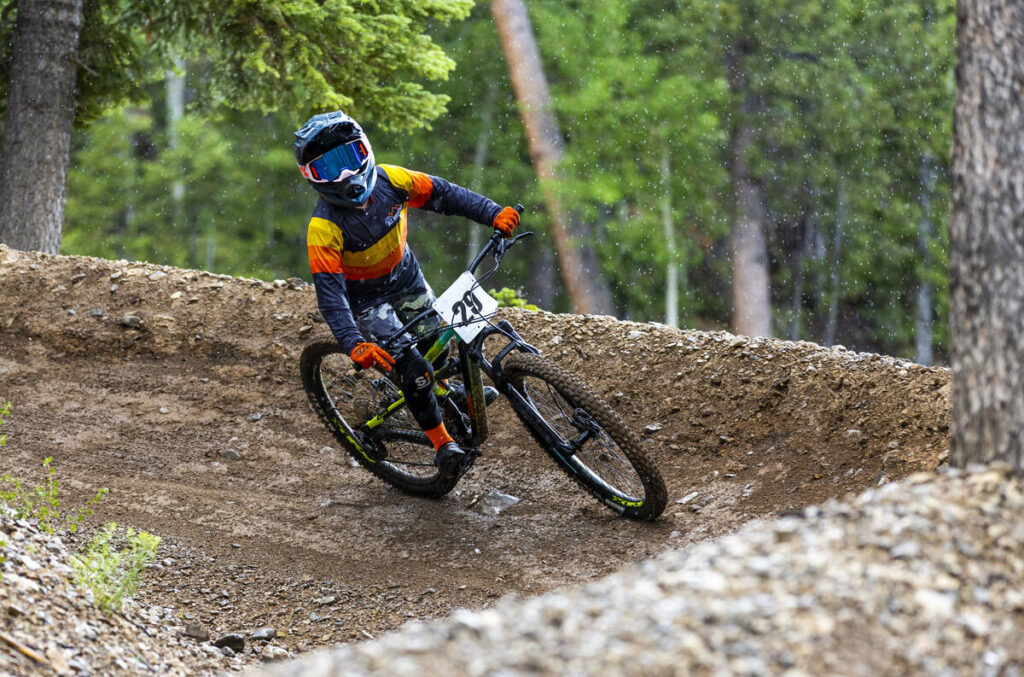 Youth boy rider Mason Conarro turns a corner as the rain comes down during the Viva La Gravity ...