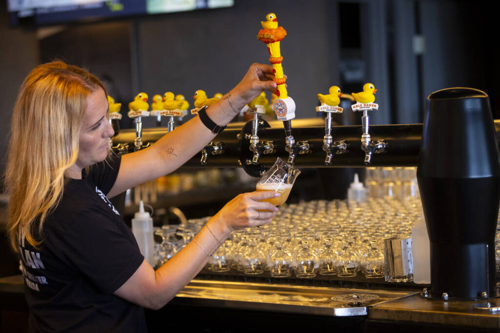 Ashley Wagner, general manager, pours the Atomic Duck IPA ahead of the opening of Able Baker Bo ...