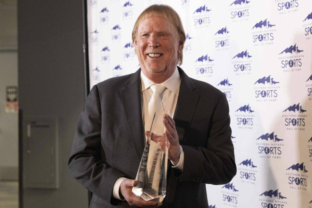 Raiders owner Mark Davis holds up his trophy received following his induction ceremony to the S ...