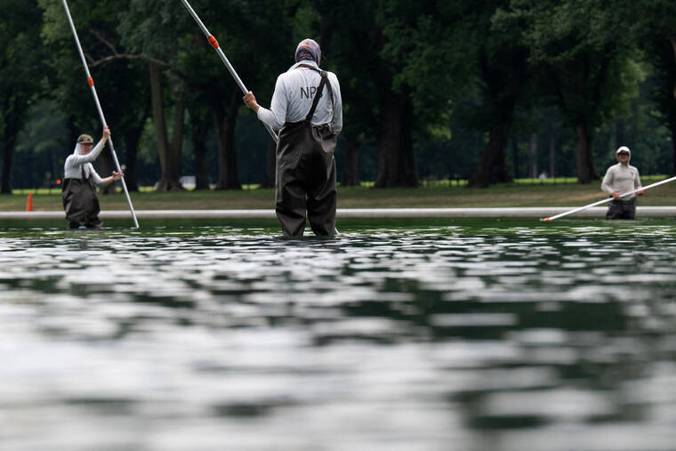 REUTERS/ANNABELLE GORDON
                                Members of the National Park Service clean the Lincoln Memorial Reflecting Pool today after recent renovations following a directive from President Donald Trump to paint it blue ahead of the 250th anniversary of U.S. Independence, in Washington, D.C.