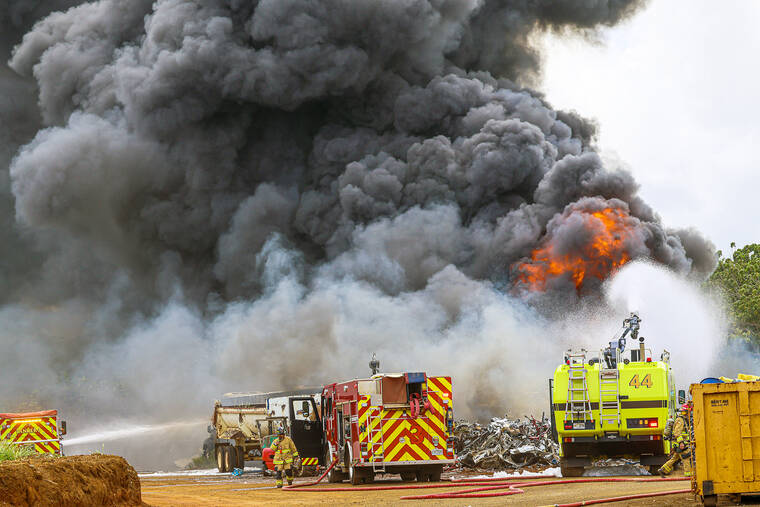 DENNIS FUJIMOTO/THE GARDEN ISLAND
                                Kauai Fire Department is joined by the Lihue Airport Rescue and Fire in fighting active flames on Wednesday during a multi-vehicle fire near Isenberg Park in Lihue.