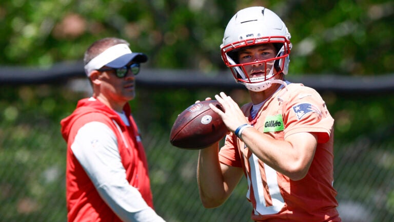 New England Patriots quarterback Drake Maye (10) throws the ball as offensive coordinator Josh McDaniels looks on during practice at Gillette Stadium on June 9, 2026 in Foxborough.
