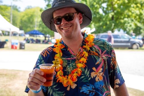 FREE Dragon Boat Race and Festival returns Aug 8—how to experience it 9 Man in a tropical shirt and lei holding a cocktail at the Dragon Boat Festival cocktail contest