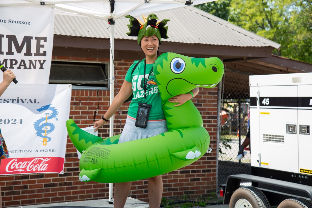 Plan now for these 34 weekend events: July 16-19, 2026 7 A smiling festival-goer wearing a dragon hat and holding an inflatable dragon at the Mitchell's Place Dragon Boat Race & Festival