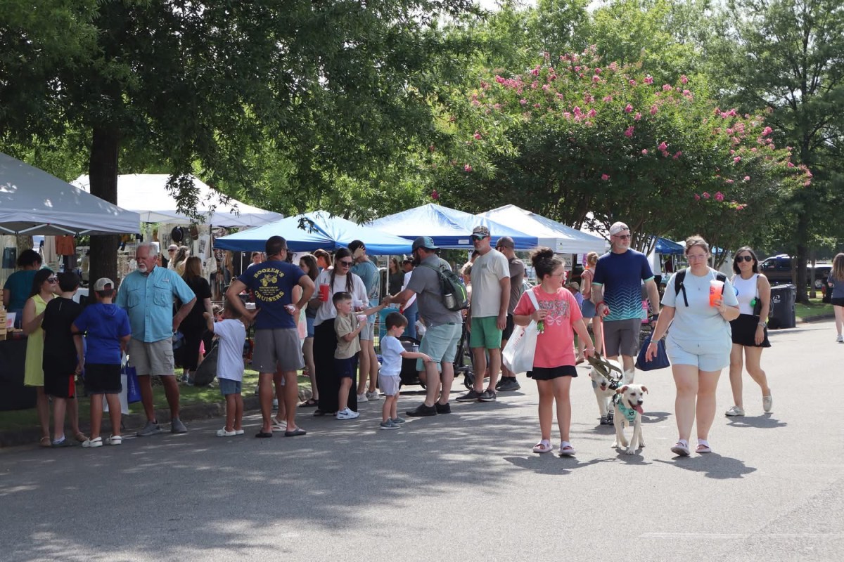 4 reasons this FREE Trussville festival is the perfect way to wrap up summer 2 Families and a dog stroll past vendor tents at a previous Trussville Dog Daze festival on a sunny summer day