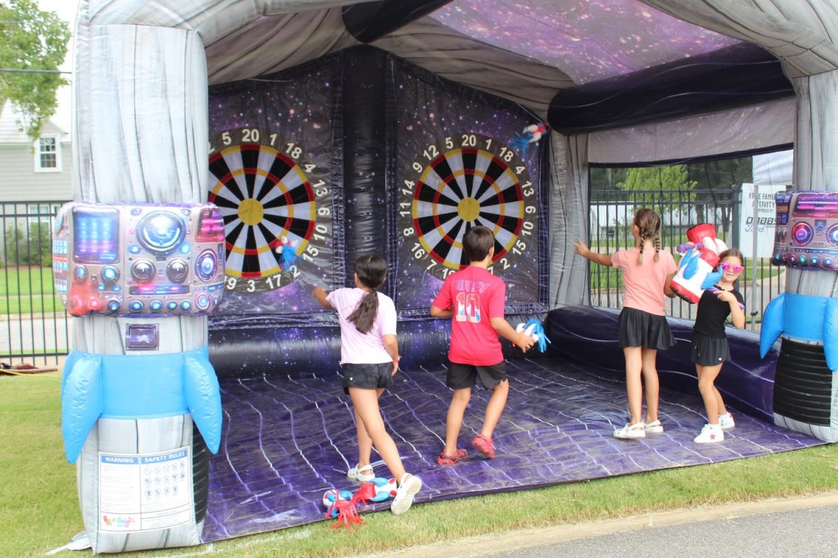 4 reasons this FREE Trussville festival is the perfect way to wrap up summer 4 Children playing an inflatable dart board game at a previous Trussville Dog Daze festival Kids Zone
