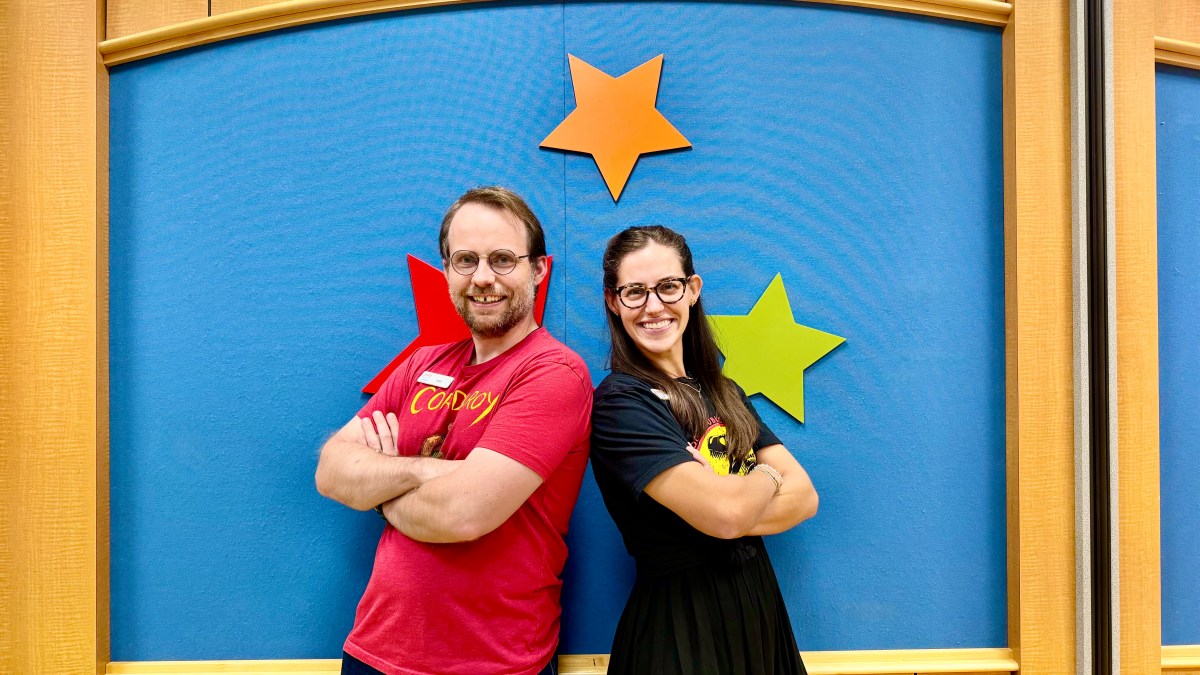 two Hoover Public Library team members standing in front of blue wall with stars