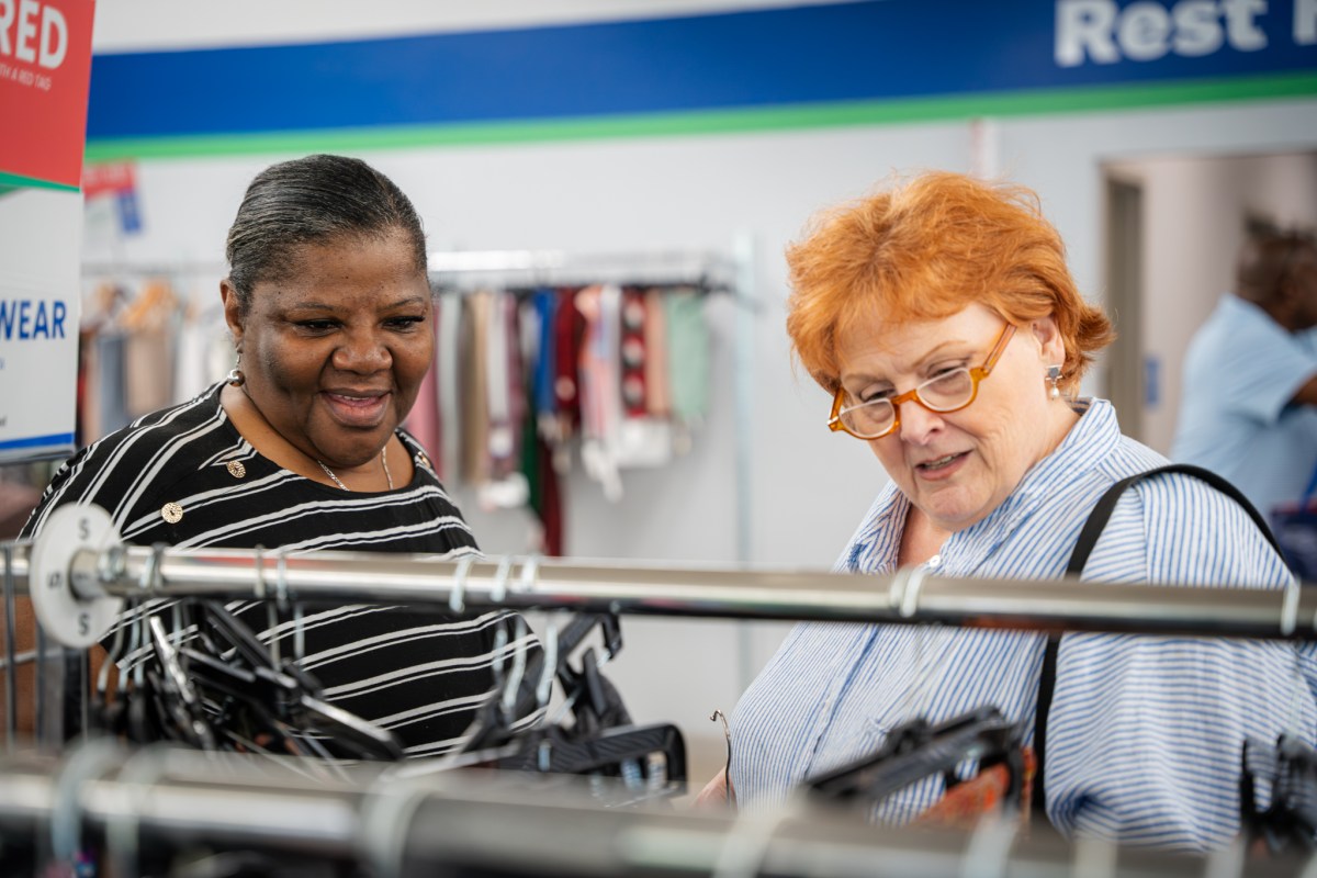See thrifted looks strut the runway + support a great cause—Aug. 26 7 two women shopping clothing racks at Alabama Goodwill in Birmingham