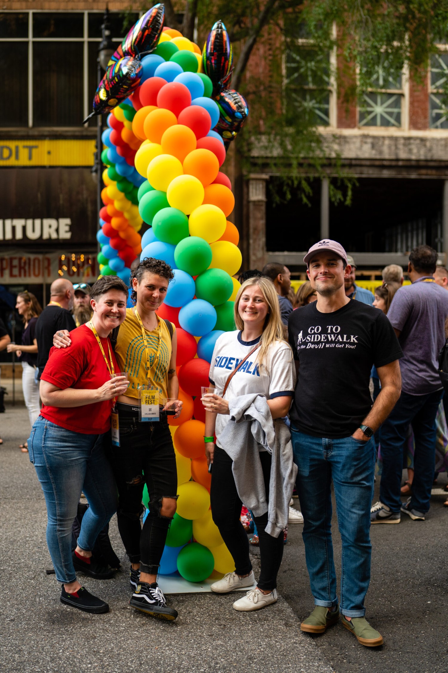 Everything you need to know about the 28th Sidewalk Film Festival in Birmingham (August 24-30, 2026) 5 Four Sidewalk Film Festival attendees posing in front of a rainbow balloon column on a downtown Birmingham street
