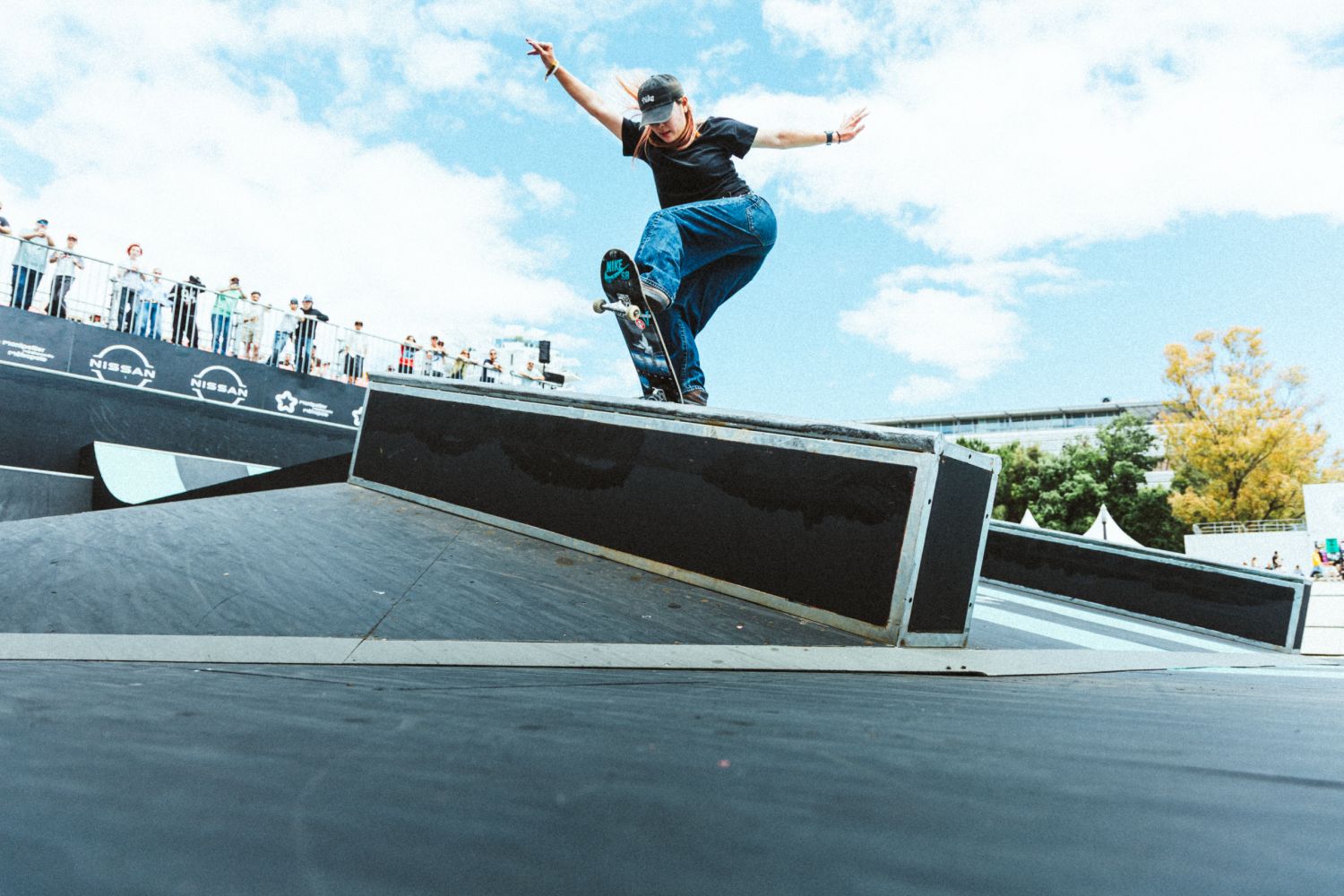 Everything you need to know about FISE in Birmingham Aug 7-9: world-class sports, live music + more 4 Skateboarder performing a trick on a rail at an outdoor skate competition with spectators watching in the background