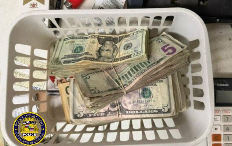 COURTESY HPD
                                Seized cash is seen at the site of a gambling raid in Ewa Beach on Thursday.
