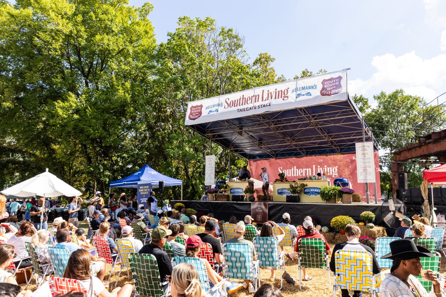 Crowd seated in lawn chairs watching a demonstration on the Southern Living Hellmann's Tailgate Stage at the South Bound Food Festival